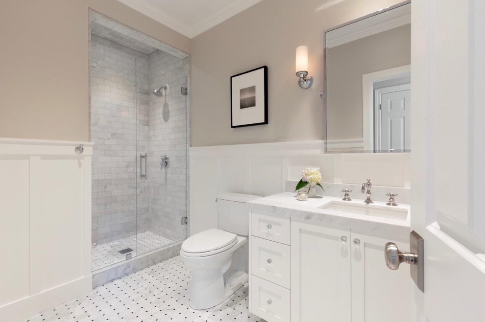 This is an example of a classic bathroom in San Francisco with shaker cabinets, white cabinets, an alcove shower, a two-piece toilet, grey tiles, marble tiles, grey walls, marble flooring, a submerged sink, marble worktops, white floors, a hinged door and white worktops.