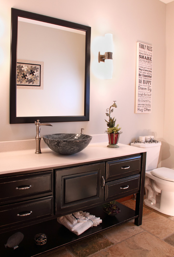 Photo of a small classic bathroom in Minneapolis with a vessel sink, raised-panel cabinets, black cabinets, marble worktops, a two-piece toilet, beige walls and travertine flooring.