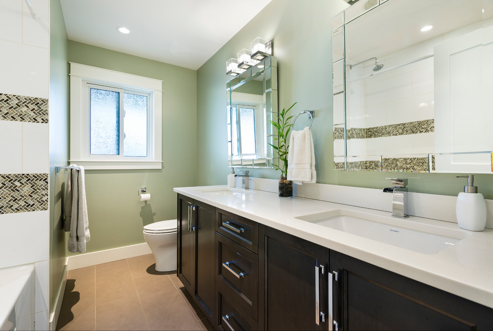 Inspiration for a large transitional kids' white tile and porcelain tile porcelain tile bathroom remodel in Vancouver with shaker cabinets, dark wood cabinets, a two-piece toilet, green walls, an undermount sink and quartz countertops