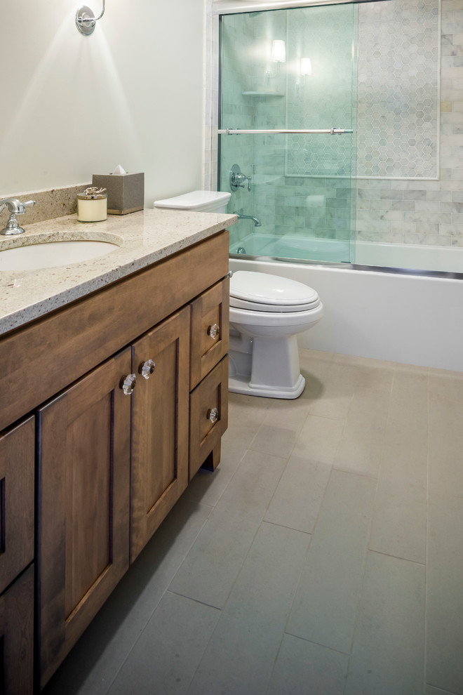 Inspiration for a mid-sized transitional kids' gray tile and ceramic tile ceramic tile tub/shower combo remodel in Chicago with an undermount sink, shaker cabinets, distressed cabinets, granite countertops, a one-piece toilet and green walls