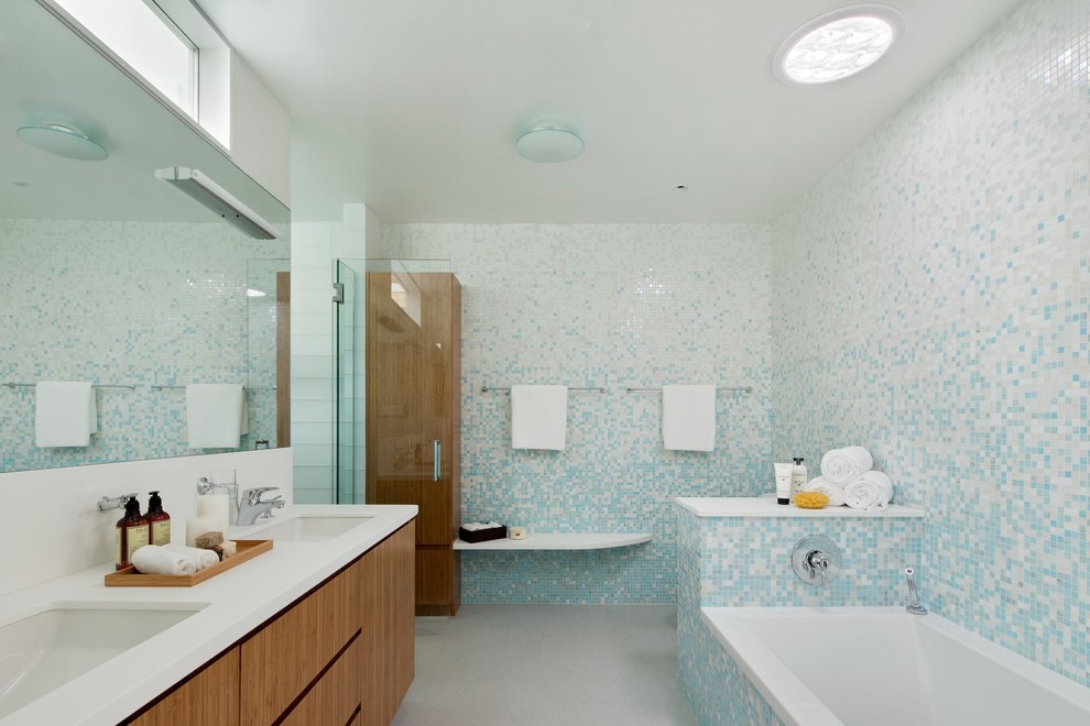 Example of a huge transitional master blue tile and mosaic tile porcelain tile bathroom design in New York with flat-panel cabinets, medium tone wood cabinets, multicolored walls, an undermount sink and quartzite countertops