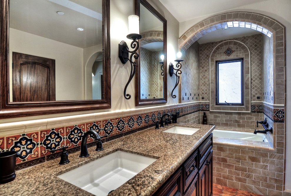 Example of a mid-sized tuscan master beige tile and mosaic tile porcelain tile and brown floor corner shower design in Orange County with raised-panel cabinets, brown cabinets, white walls, an undermount sink, granite countertops and a hinged shower door