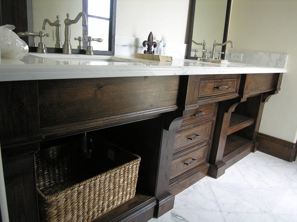 Inspiration for a large timeless master marble floor bathroom remodel in San Diego with furniture-like cabinets, dark wood cabinets, marble countertops and beige walls