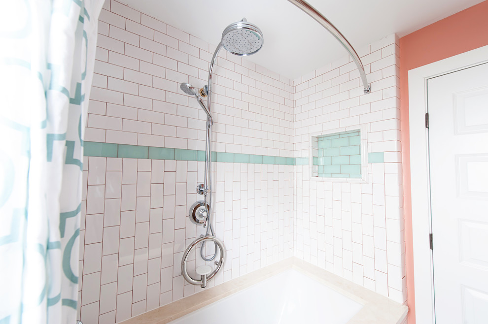 Example of a small country 3/4 white tile and ceramic tile concrete floor tub/shower combo design in DC Metro with marble countertops, an undermount tub, furniture-like cabinets, medium tone wood cabinets, a two-piece toilet, pink walls and an undermount sink