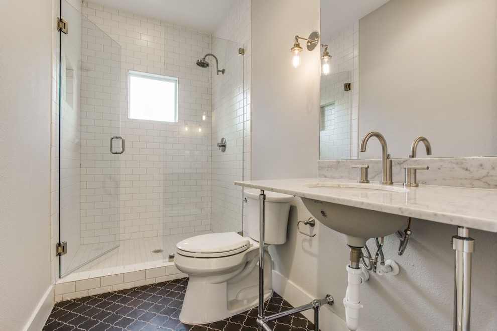 Photo of a medium sized classic shower room bathroom in Dallas with open cabinets, an alcove shower, a two-piece toilet, white tiles, metro tiles, grey walls, porcelain flooring, a submerged sink, marble worktops, black floors and a hinged door.