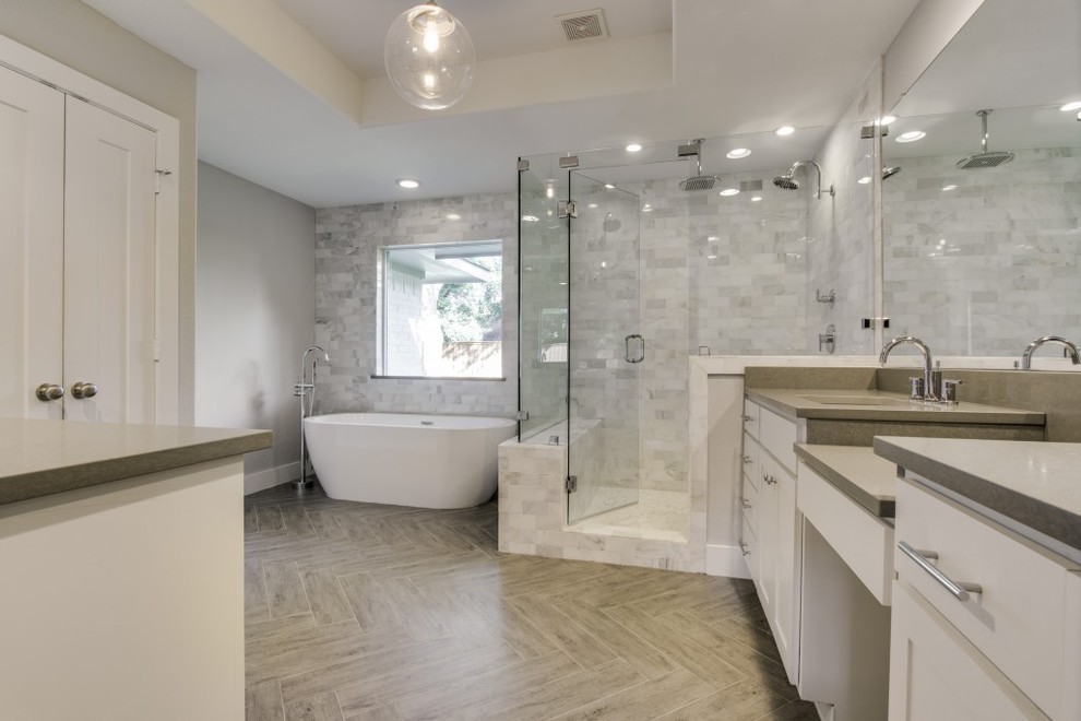 Bathroom - large transitional master gray tile and marble tile porcelain tile and beige floor bathroom idea in Dallas with shaker cabinets, white cabinets, gray walls, an undermount sink, quartzite countertops and a hinged shower door
