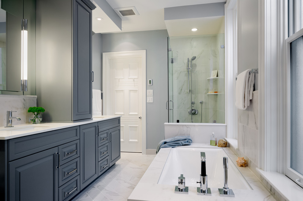 Bathroom - mid-sized contemporary master gray tile, multicolored tile, white tile and stone tile marble floor and gray floor bathroom idea in Philadelphia with raised-panel cabinets, blue cabinets, a two-piece toilet, blue walls, an undermount sink, quartz countertops and a hinged shower door