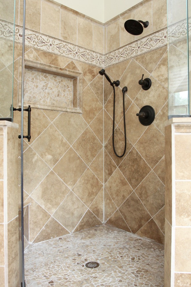 Large traditional ensuite bathroom in Other with raised-panel cabinets, dark wood cabinets, a claw-foot bath, a corner shower, a two-piece toilet, beige tiles, stone tiles, travertine flooring, a submerged sink and granite worktops.