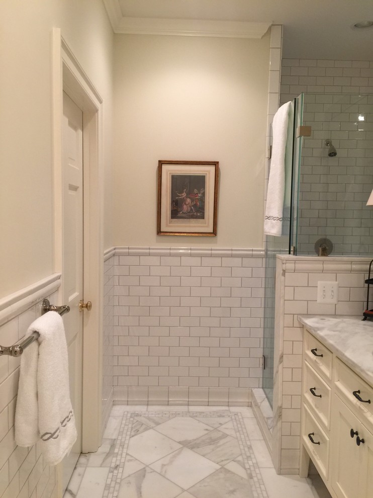 Large eclectic ensuite bathroom in DC Metro with freestanding cabinets, white cabinets, a freestanding bath, a double shower, a two-piece toilet, brown tiles, stone tiles, white walls, marble flooring, a submerged sink and marble worktops.