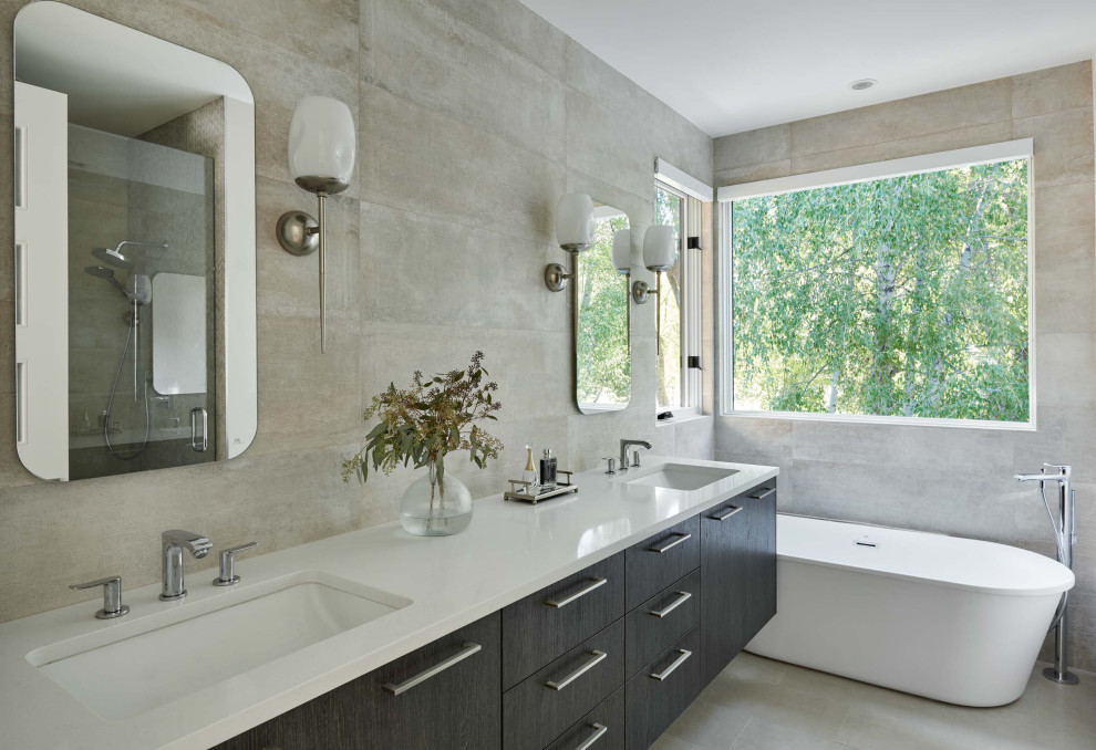 Freestanding bathtub - mid-sized contemporary master gray tile and cement tile cement tile floor, gray floor and double-sink freestanding bathtub idea in Denver with flat-panel cabinets, dark wood cabinets, a two-piece toilet, gray walls, an undermount sink, quartz countertops and white countertops
