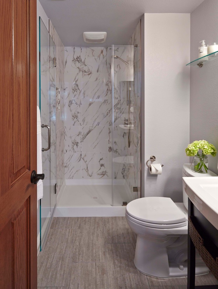 Inspiration for a small contemporary 3/4 white tile and stone tile limestone floor alcove shower remodel in San Francisco with a wall-mount sink, furniture-like cabinets, dark wood cabinets, solid surface countertops, a one-piece toilet and gray walls