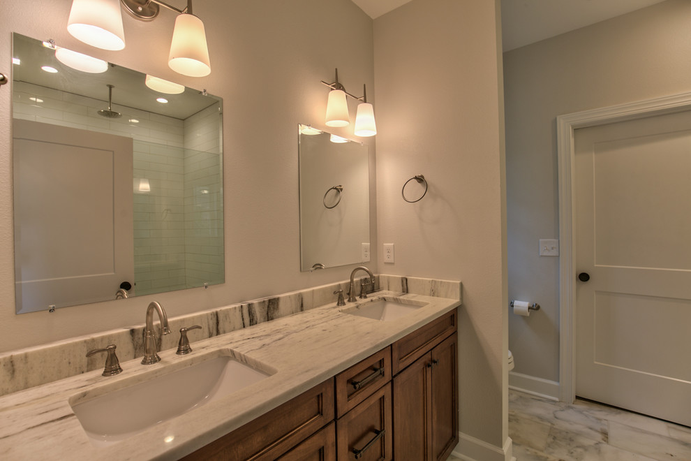 Inspiration for a mid-sized master marble floor and beige floor bathroom remodel in Atlanta with shaker cabinets, medium tone wood cabinets, gray walls, a drop-in sink and granite countertops