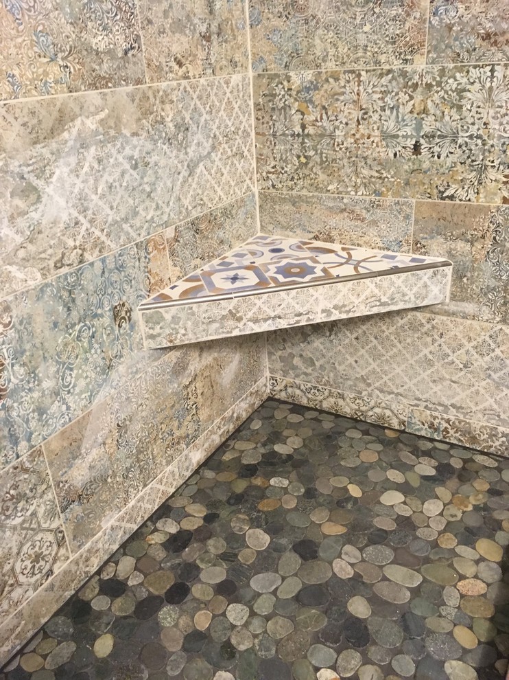 Alcove shower - mid-sized mediterranean 3/4 multicolored tile and cement tile medium tone wood floor and gray floor alcove shower idea in Miami with shaker cabinets, white cabinets, multicolored walls, an undermount sink, solid surface countertops, a hinged shower door and black countertops