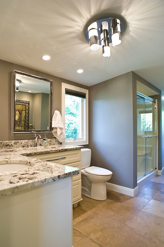 Photo of a large traditional ensuite bathroom in Other with recessed-panel cabinets, an alcove shower, a two-piece toilet, brown walls, a submerged sink and a hinged door.