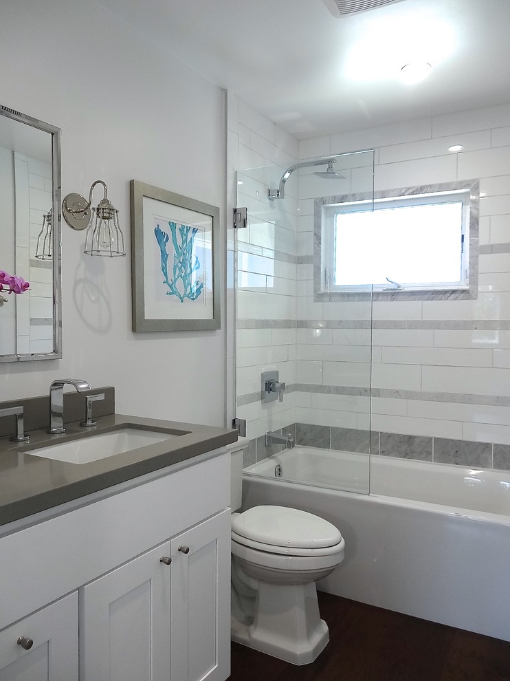 Inspiration for a mid-sized transitional white tile and stone tile bathroom remodel in Los Angeles with an undermount sink, shaker cabinets, white cabinets, quartz countertops, a two-piece toilet and white walls