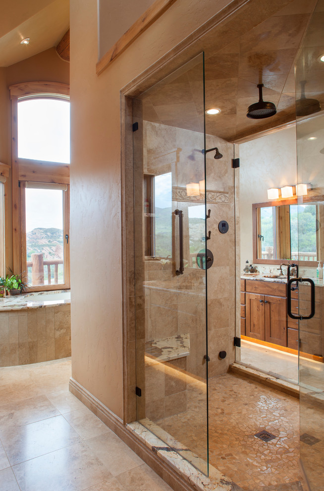 Inspiration for a large rustic master beige tile and ceramic tile ceramic tile and beige floor double shower remodel in Denver with shaker cabinets, medium tone wood cabinets, beige walls, an undermount sink, granite countertops and a hinged shower door