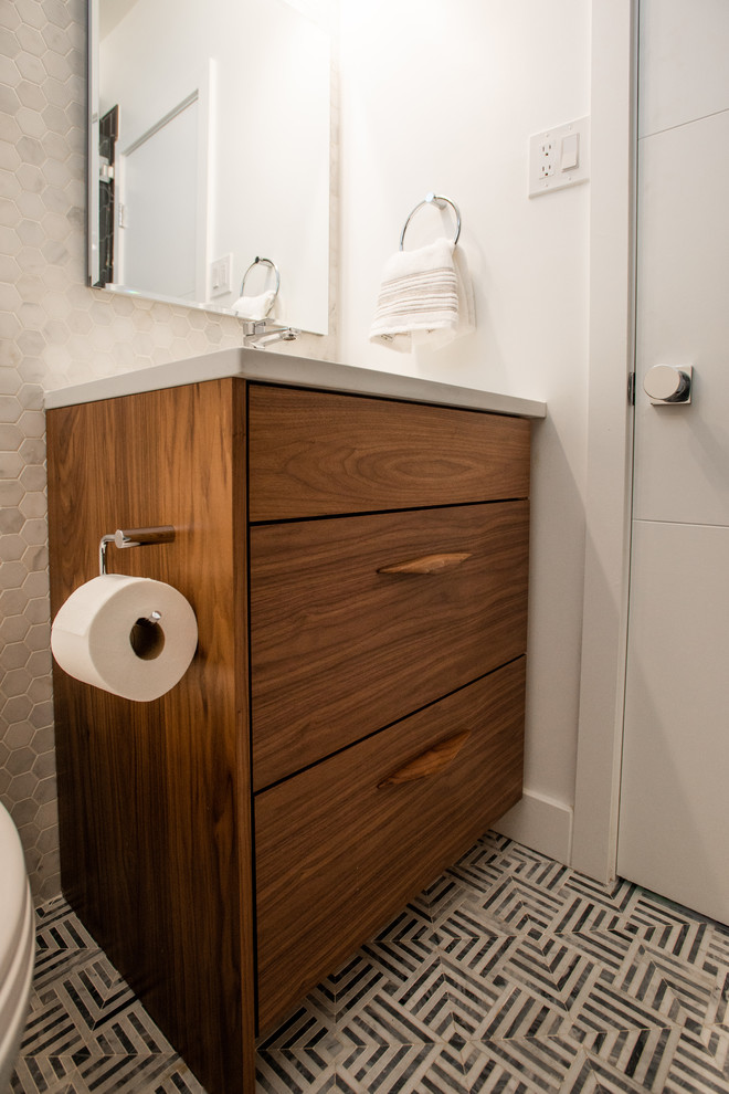 Mid-sized trendy master white tile and subway tile mosaic tile floor and multicolored floor bathroom photo in Denver with flat-panel cabinets, medium tone wood cabinets, a one-piece toilet, white walls, an undermount sink, quartz countertops, a hinged shower door and white countertops