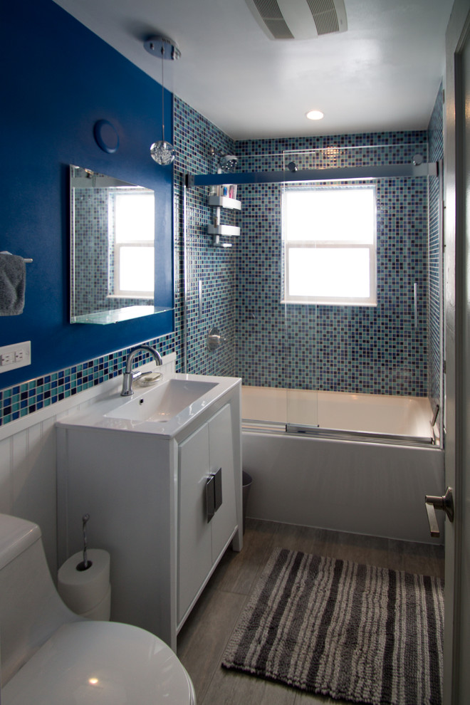 Inspiration for a small eclectic master blue tile and glass tile porcelain tile and gray floor bathroom remodel in Denver with flat-panel cabinets, white cabinets, a one-piece toilet, blue walls, an undermount sink and quartz countertops