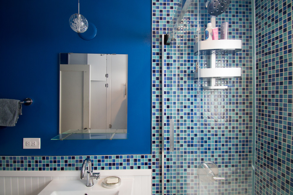 Design ideas for a small eclectic ensuite bathroom in Denver with flat-panel cabinets, white cabinets, an alcove bath, a shower/bath combination, a one-piece toilet, blue tiles, glass tiles, blue walls, porcelain flooring, a submerged sink, engineered stone worktops, grey floors and a sliding door.