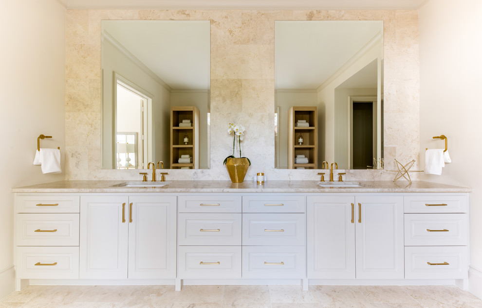 Traditional bathroom in Dallas with recessed-panel cabinets, white cabinets, beige tiles, beige walls, a submerged sink, beige floors and beige worktops.