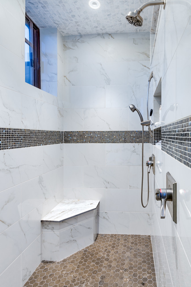 Mid-sized southwest master multicolored tile and stone tile limestone floor alcove shower photo in Phoenix with recessed-panel cabinets, medium tone wood cabinets, an undermount tub, a one-piece toilet, an undermount sink and marble countertops