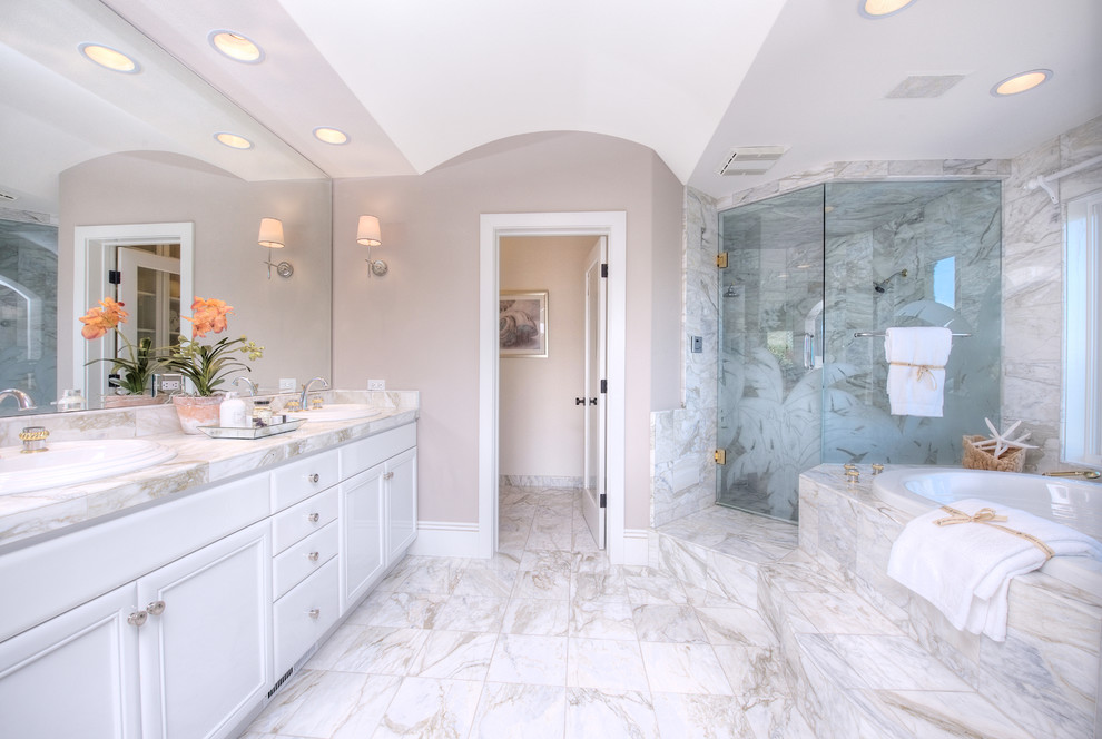 Bathroom - mid-sized mediterranean master white tile and stone tile marble floor bathroom idea in San Francisco with an undermount sink, recessed-panel cabinets, white cabinets, marble countertops and beige walls