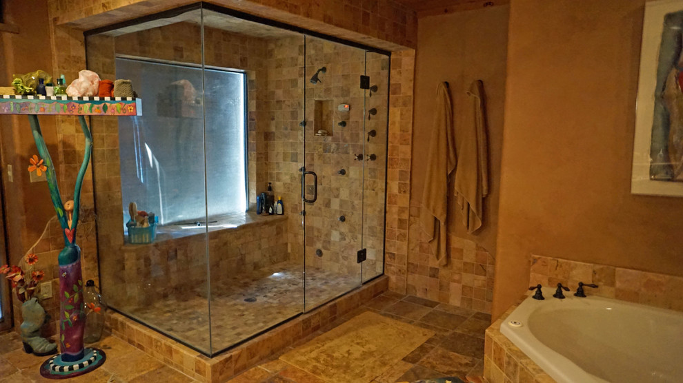 Inspiration for a large rustic sauna bathroom in Phoenix with medium wood cabinets, a corner bath, multi-coloured tiles, stone tiles, brown walls and ceramic flooring.