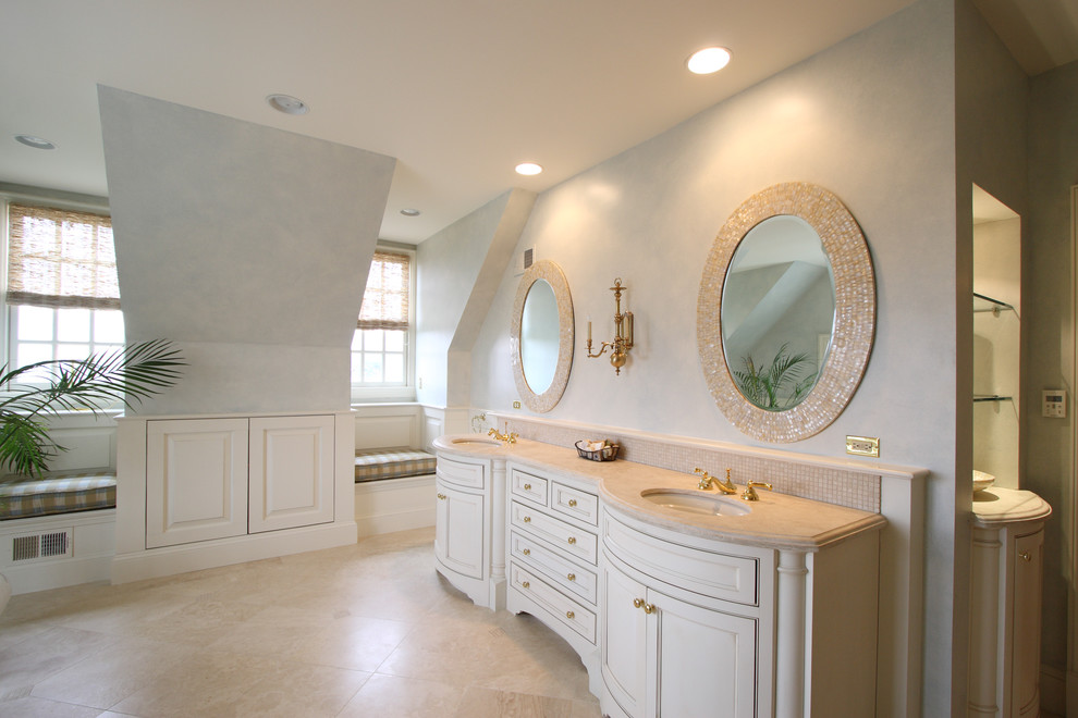 Photo of a traditional bathroom in DC Metro with white cabinets and beaded cabinets.