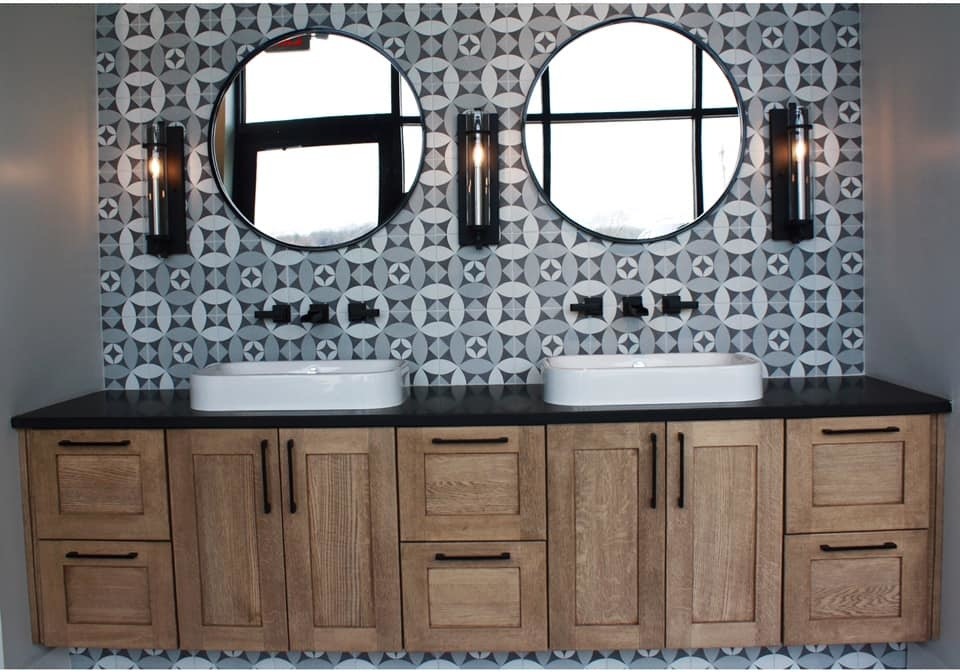 Example of a trendy black and white tile and mosaic tile bathroom design in Indianapolis with medium tone wood cabinets and black countertops