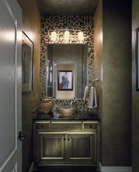 This is an example of a small classic bathroom in Kansas City with a vessel sink, recessed-panel cabinets, granite worktops, multi-coloured tiles, stone tiles, multi-coloured walls, medium hardwood flooring and dark wood cabinets.