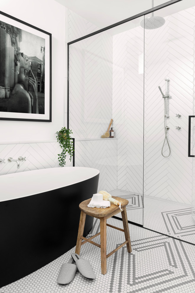 This is an example of a large scandinavian ensuite bathroom in Montreal with black cabinets, a freestanding bath, an alcove shower, a one-piece toilet, white tiles, ceramic tiles, white walls, mosaic tile flooring, a submerged sink, engineered stone worktops, black floors, a hinged door, white worktops, a wall niche, double sinks and a floating vanity unit.