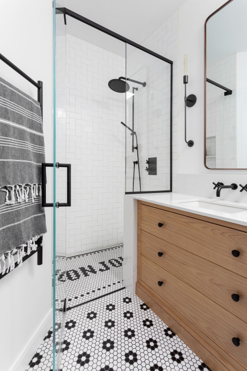 Modern Harmony: Black and White Penny Tile Bathroom Floor with Wood Vanity