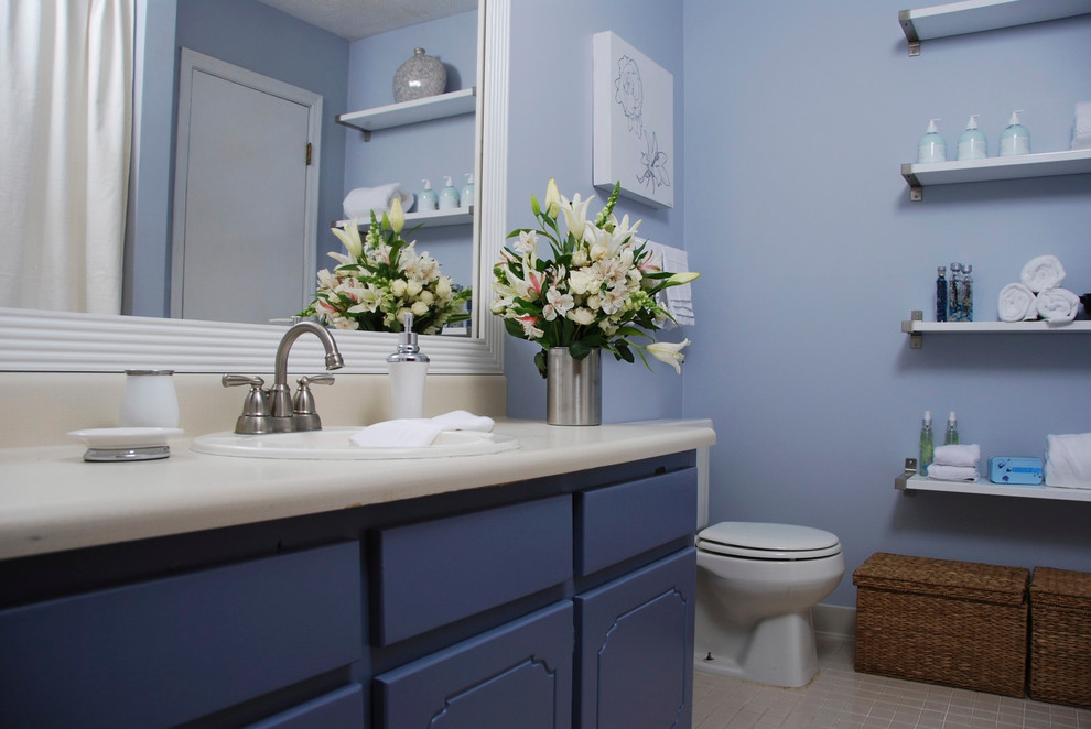 Inspiration for a small ensuite bathroom in Atlanta with flat-panel cabinets, blue cabinets, blue walls, ceramic flooring and laminate worktops.