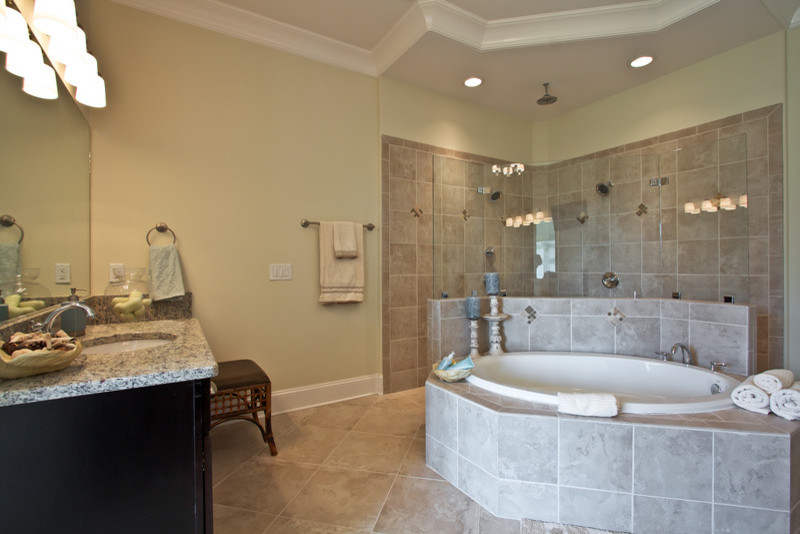 Example of a mid-sized classic master ceramic tile bathroom design in Nashville with recessed-panel cabinets, dark wood cabinets, a two-piece toilet, beige walls, an undermount sink and laminate countertops