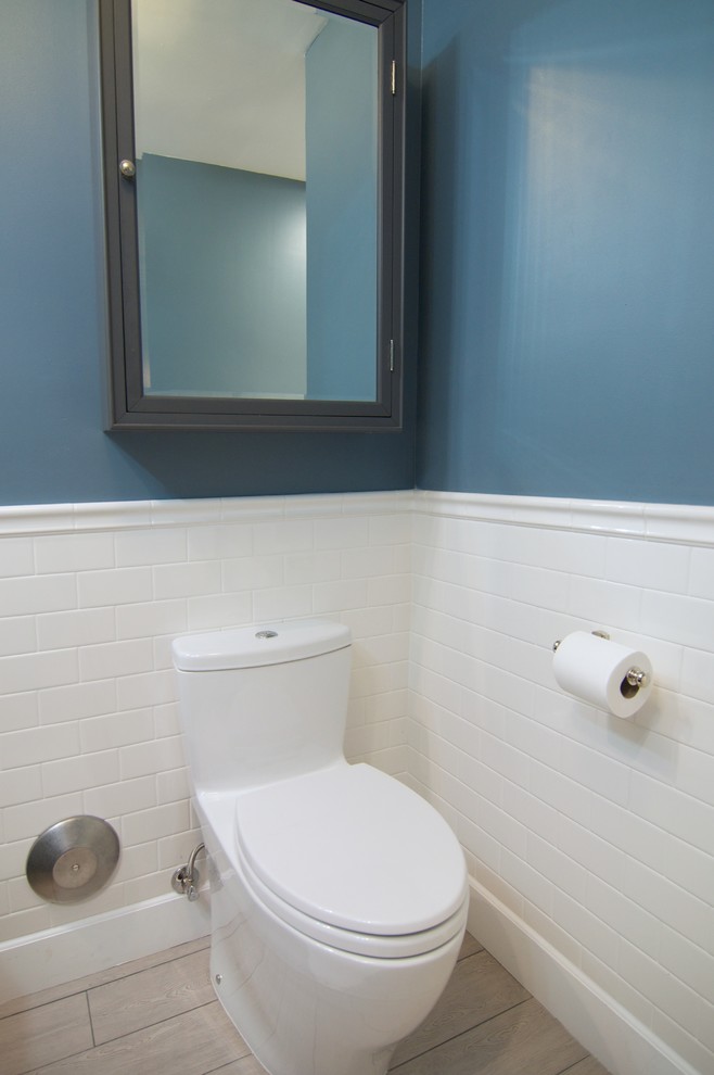 Photo of a classic cloakroom in Orange County with a built-in sink, freestanding cabinets, grey cabinets, marble worktops, a one-piece toilet, white tiles and porcelain tiles.