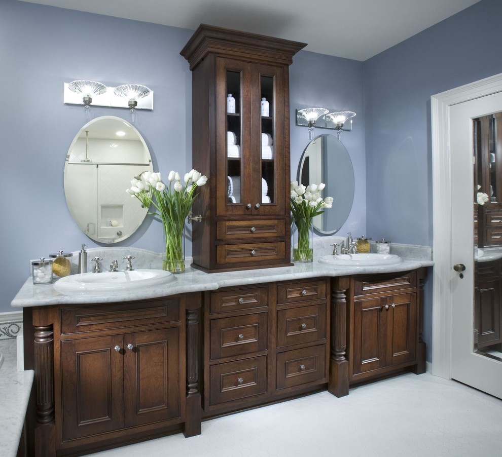 Exempel på ett stort klassiskt en-suite badrum, med ett nedsänkt handfat, luckor med profilerade fronter, skåp i mörkt trä, marmorbänkskiva, ett platsbyggt badkar, grå kakel, stenkakel, blå väggar och klinkergolv i porslin