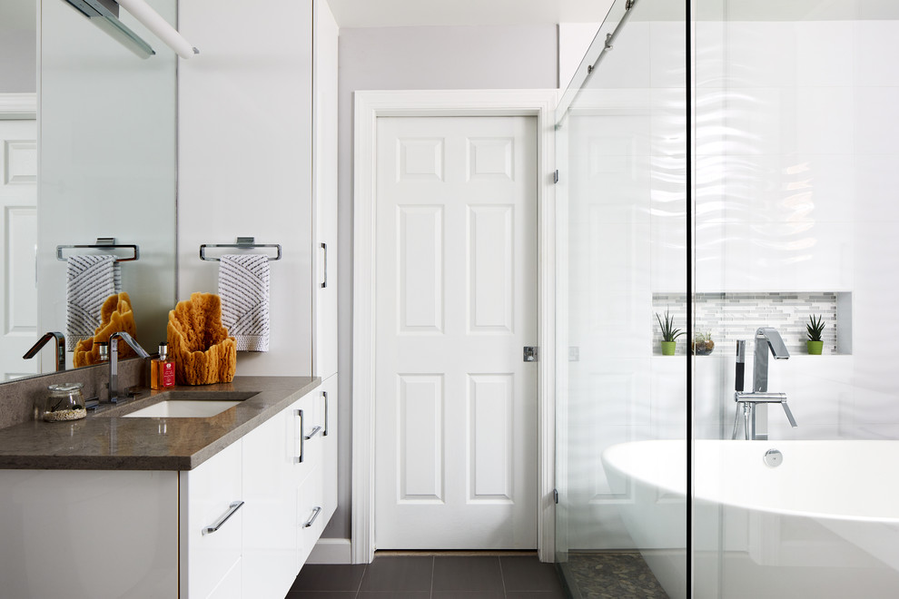 Example of a mid-sized trendy master white tile and ceramic tile porcelain tile and gray floor bathroom design in Chicago with flat-panel cabinets, white cabinets, gray walls, an undermount sink, quartz countertops and gray countertops