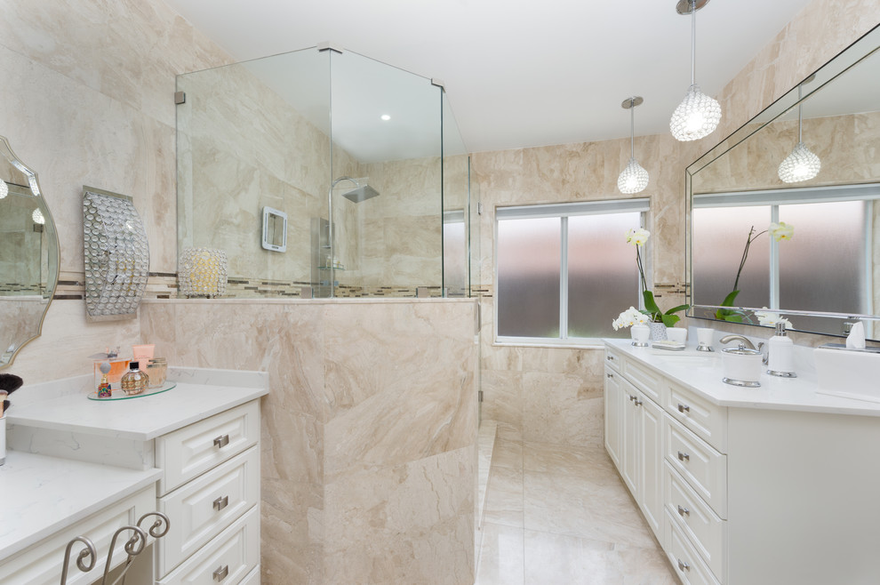 Inspiration for a medium sized traditional ensuite bathroom in Miami with white cabinets, a corner shower, beige tiles, marble tiles, beige walls, marble flooring, a submerged sink, beige floors and a hinged door.