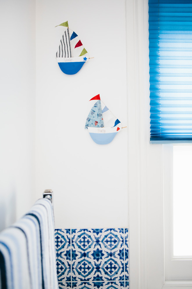 Example of a small beach style kids' blue tile and ceramic tile bathroom design in London with white walls