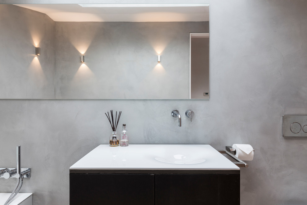 Bild på ett mellanstort funkis badrum med dusch, med öppna hyllor, grå skåp, en öppen dusch, en toalettstol med hel cisternkåpa, grå väggar, betonggolv, ett nedsänkt handfat, bänkskiva i betong, grått golv och med dusch som är öppen