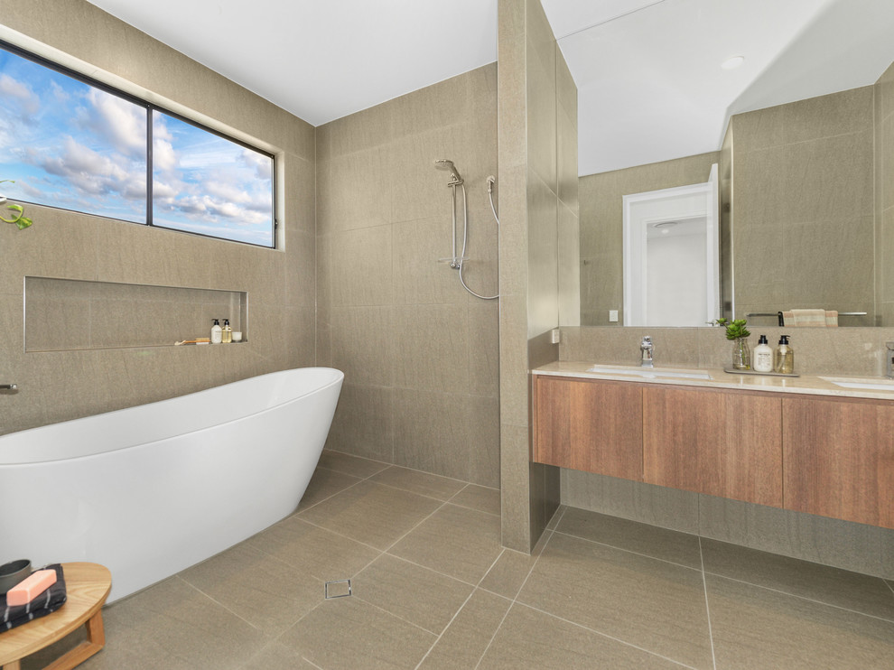 Design ideas for a contemporary shower room bathroom in Brisbane with medium wood cabinets, a freestanding bath, a walk-in shower, beige tiles, ceramic tiles, beige walls, ceramic flooring, a built-in sink and marble worktops.