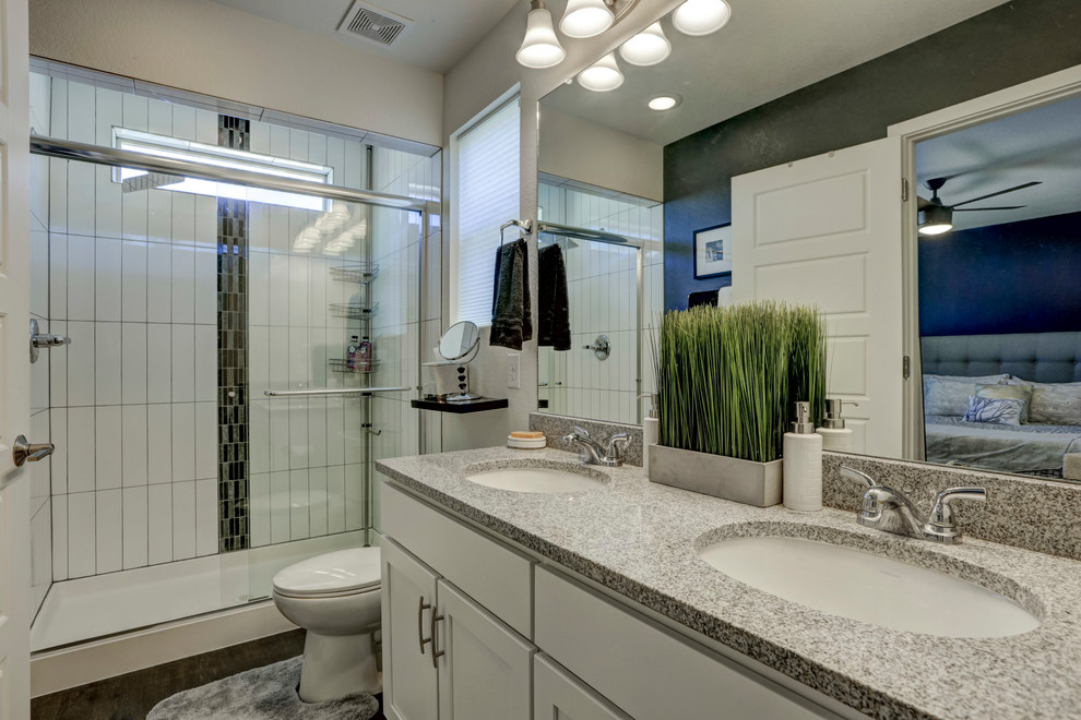 Example of a mid-sized trendy master white tile and ceramic tile vinyl floor and black floor bathroom design in Denver with shaker cabinets, white cabinets, a one-piece toilet, black walls, an undermount sink and granite countertops