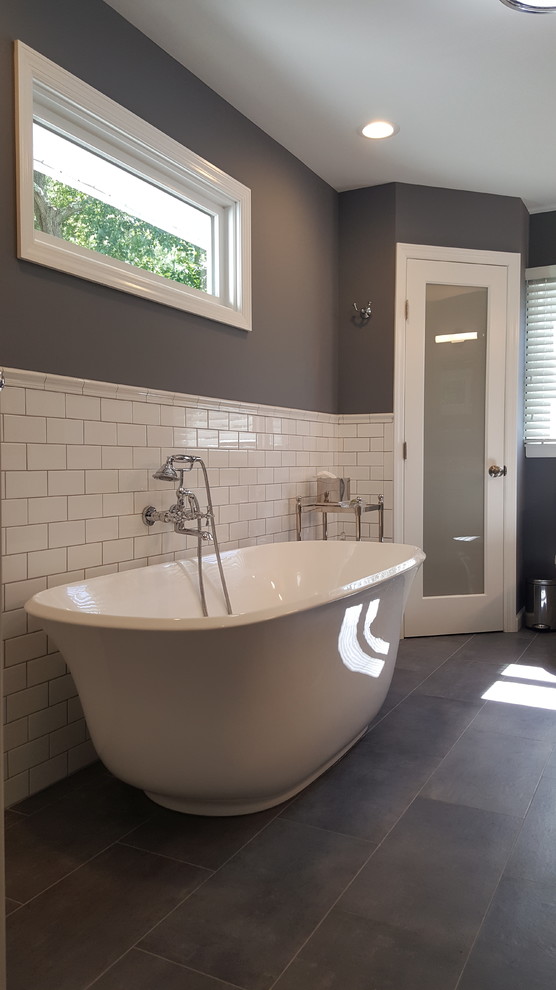 Cette image montre une grande salle de bain principale rustique avec une baignoire indépendante, un carrelage blanc, un carrelage métro, un sol en ardoise, un sol gris et un mur gris.