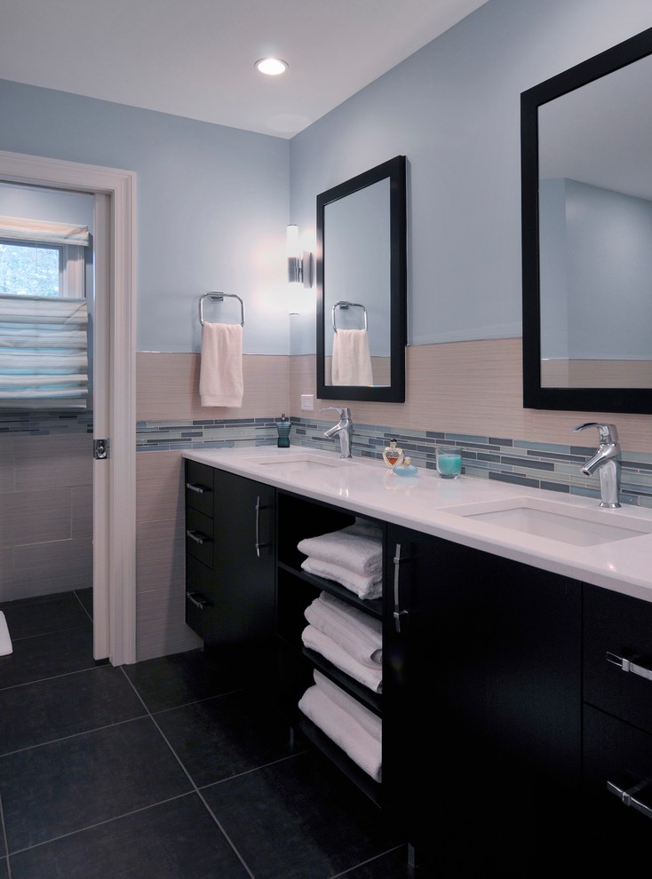 Example of a mid-sized trendy master multicolored tile and mosaic tile porcelain tile bathroom design in New York with an undermount sink, flat-panel cabinets, black cabinets, quartzite countertops, a two-piece toilet and blue walls
