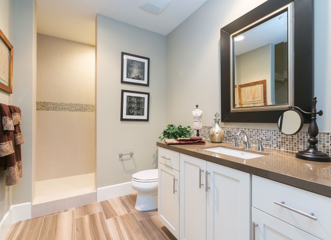 Inspiration for a large traditional ensuite bathroom in San Diego with shaker cabinets, white cabinets, a built-in bath, a walk-in shower, a one-piece toilet, multi-coloured tiles, beige walls, a submerged sink and soapstone worktops.