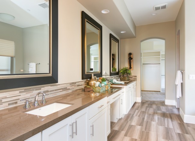 Large classic ensuite bathroom in San Diego with shaker cabinets, white cabinets, a built-in bath, a walk-in shower, a one-piece toilet, multi-coloured tiles, beige walls, a submerged sink and soapstone worktops.