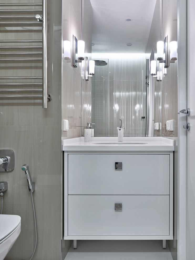 This is an example of a contemporary bathroom in Moscow with flat-panel cabinets and white cabinets.