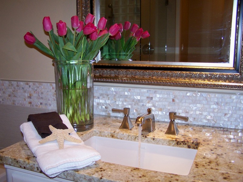 Elegant white tile walk-in shower photo in Seattle with an undermount sink and granite countertops