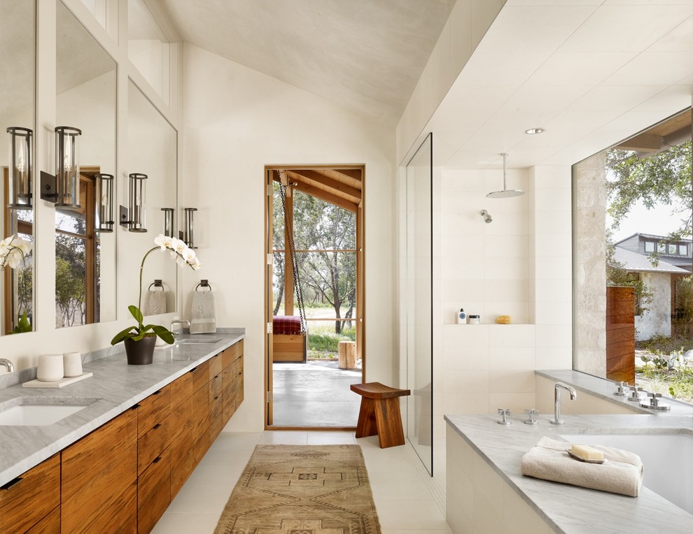 Inspiration for a medium sized contemporary ensuite bathroom in Austin with flat-panel cabinets, medium wood cabinets, a submerged bath, a built-in shower, white tiles, a submerged sink, white walls and an open shower.