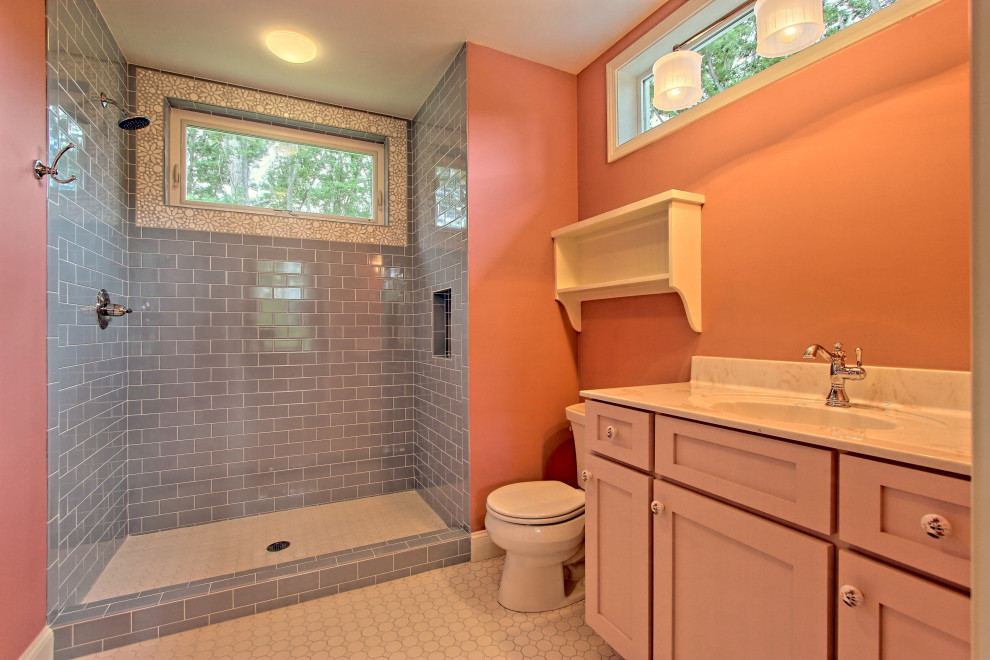 Bathroom - mid-sized eclectic ceramic tile and white floor bathroom idea in Atlanta with shaker cabinets, red cabinets, a one-piece toilet, orange walls, an undermount sink, solid surface countertops and beige countertops